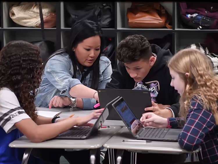 Students in a classroom using their laptops