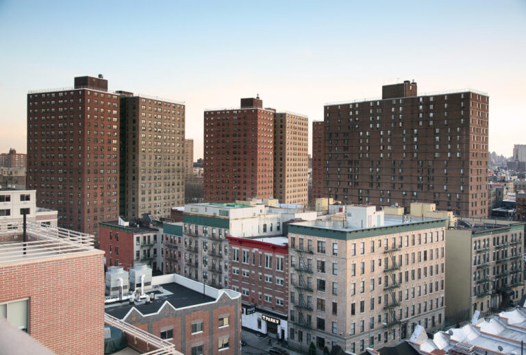 Several apartment buildings on a city block.