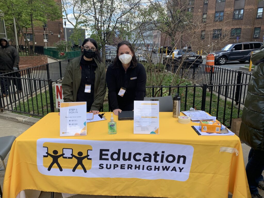 EducationSuperHighway team members at the Isaacs Center in New York City. The organization was present to assist resident in signing up for the Affordable Connectivity Program.