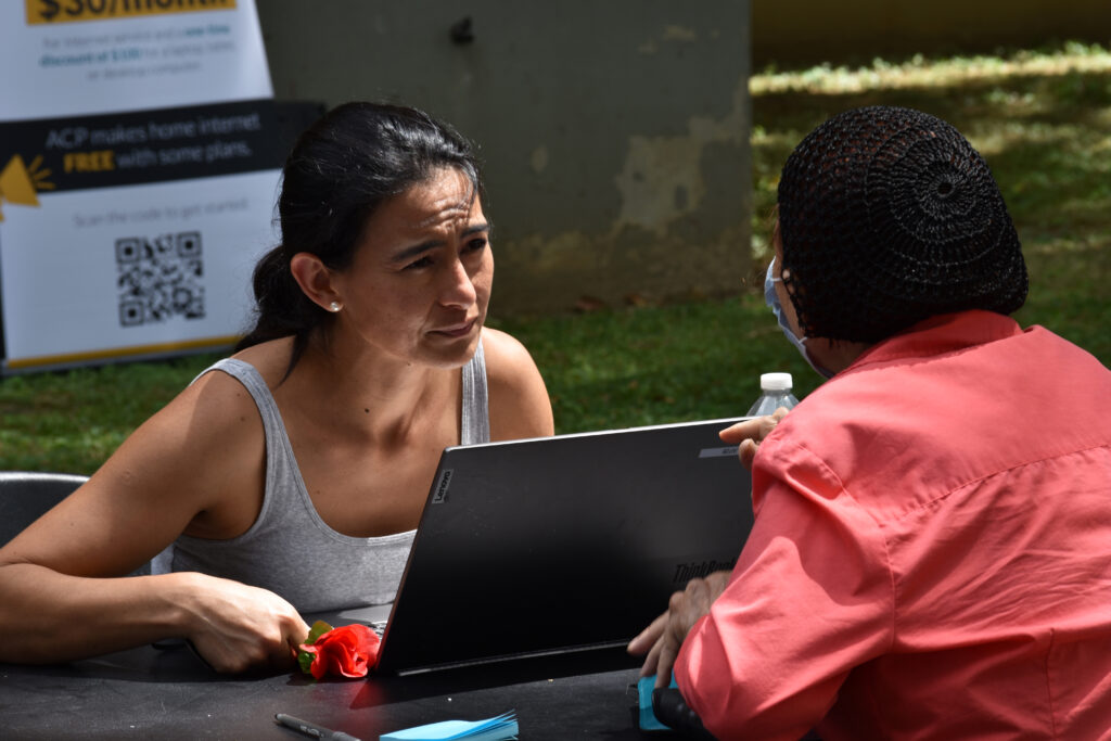 photo of a support specialist assisting a resident to enroll in the ACP