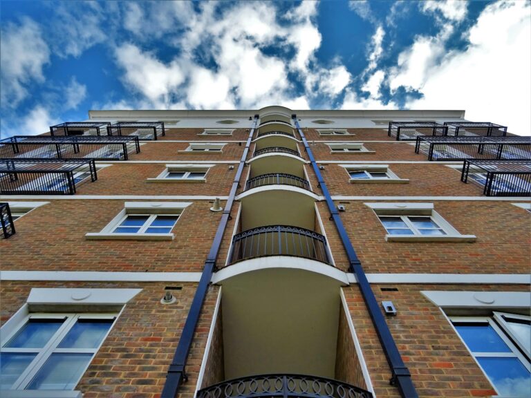 Ground-level perspective looking up at apartment building